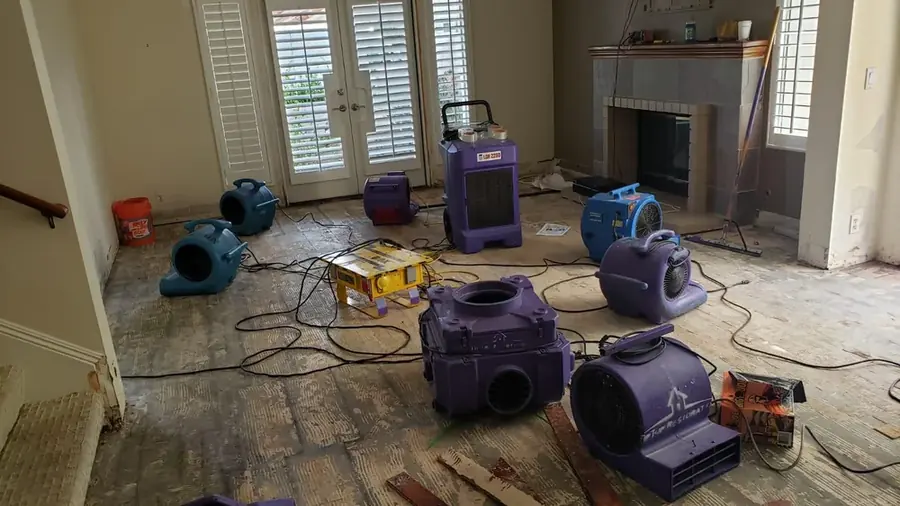 Drying equipment set in a damaged living room in a San Gabriel Valley home