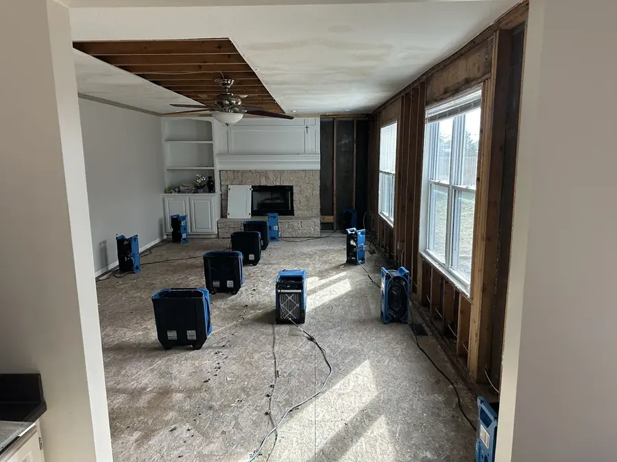 Air movers drying a room down to the studs in a San Gabriel Valley home
