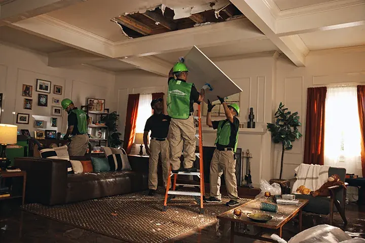 Crew removing a water damaged ceiling after a roof leak in a San Marino home